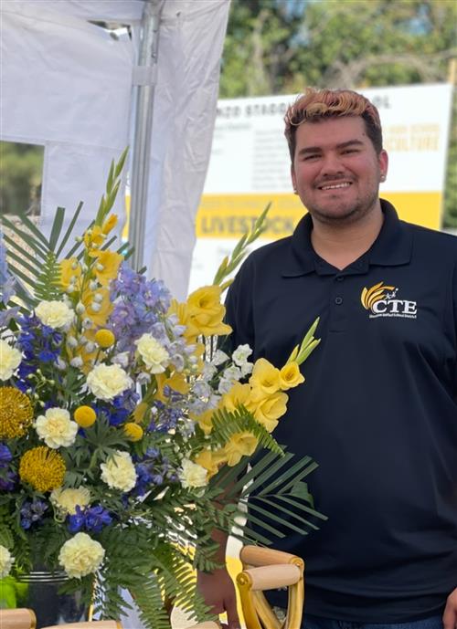 Photo of Mr. Arceo with a floral arrangement