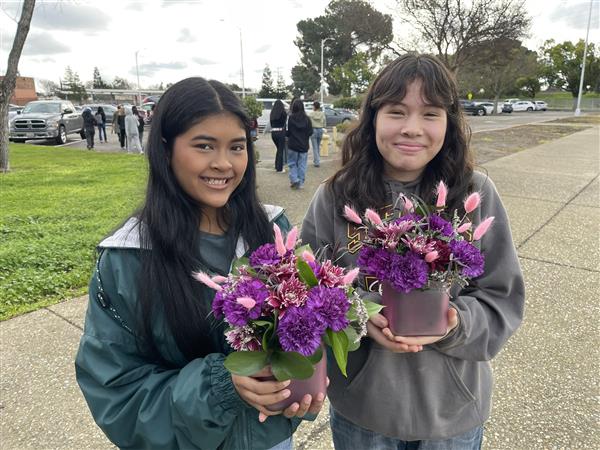 Two floriculture students with centerpieces made for the San Joaquin County Office of Education